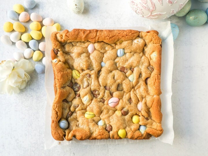 These Easter Cadbury Mini Eggs Blondies are chewy milk chocolate chip cookie bars filled with mini Cadbury eggs. These are the best mini egg blondies!