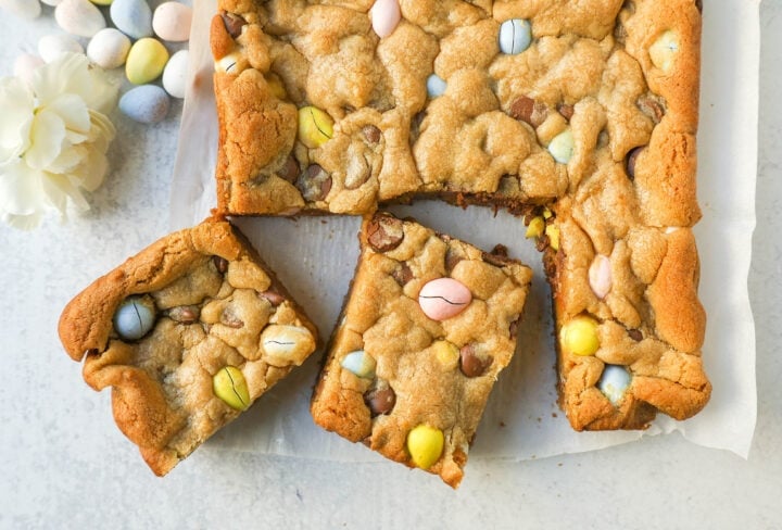 These Easter Cadbury Mini Eggs Blondies are chewy milk chocolate chip cookie bars filled with mini Cadbury eggs. These are the best mini egg blondies!