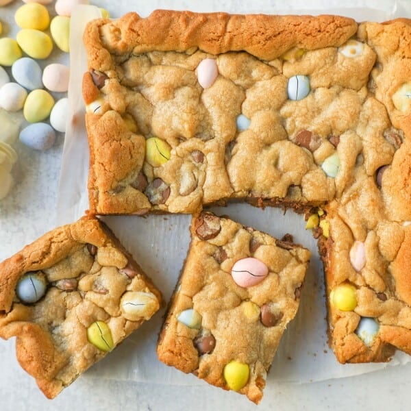 These Easter Cadbury Mini Eggs Blondies are chewy milk chocolate chip cookie bars filled with mini Cadbury eggs. These are the best mini egg blondies!