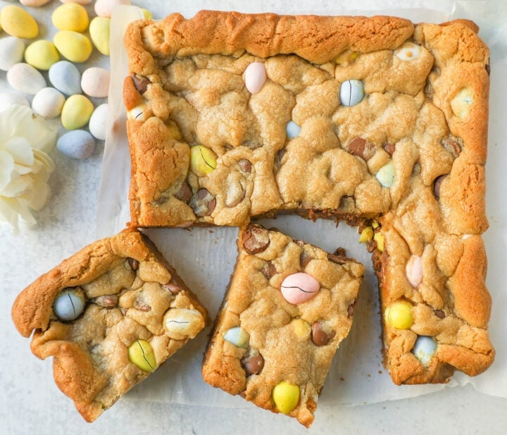 These Easter Cadbury Mini Eggs Blondies are chewy milk chocolate chip cookie bars filled with mini Cadbury eggs. These are the best mini egg blondies!