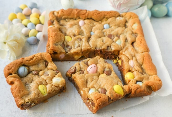 These Easter Cadbury Mini Eggs Blondies are chewy milk chocolate chip cookie bars filled with mini Cadbury eggs. These are the best mini egg blondies!