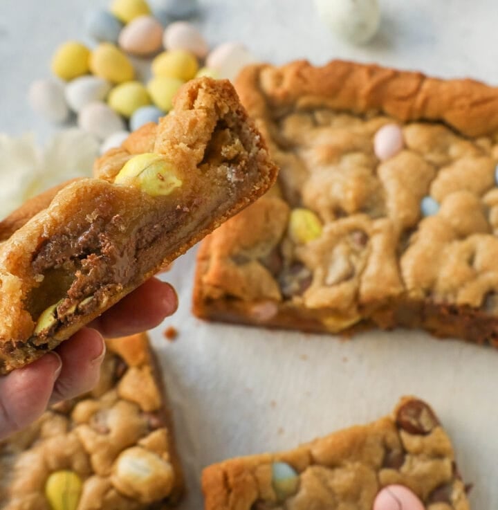 These Easter Cadbury Mini Eggs Blondies are chewy milk chocolate chip cookie bars filled with mini Cadbury eggs. These are the best mini egg blondies!