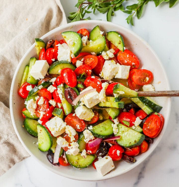 This simple Greek Salad is made with fresh tomatoes, cucumbers, red onion, kalamata olives, feta cheese, and all tossed with a homemade tangy Greek dressing. 