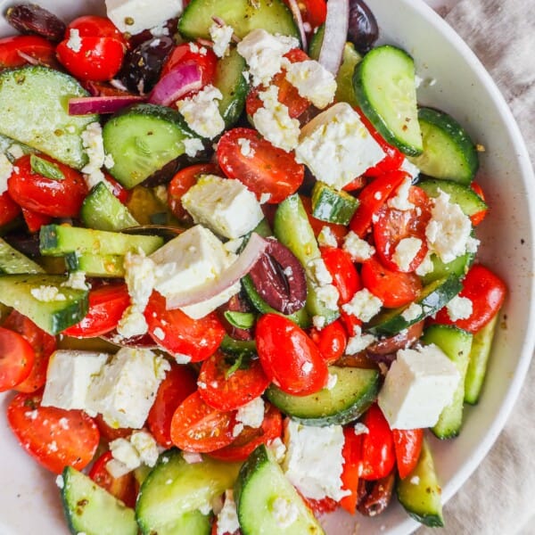 This simple Greek Salad is made with fresh tomatoes, cucumbers, red onion, kalamata olives, feta cheese, and all tossed with a homemade tangy Greek dressing. 