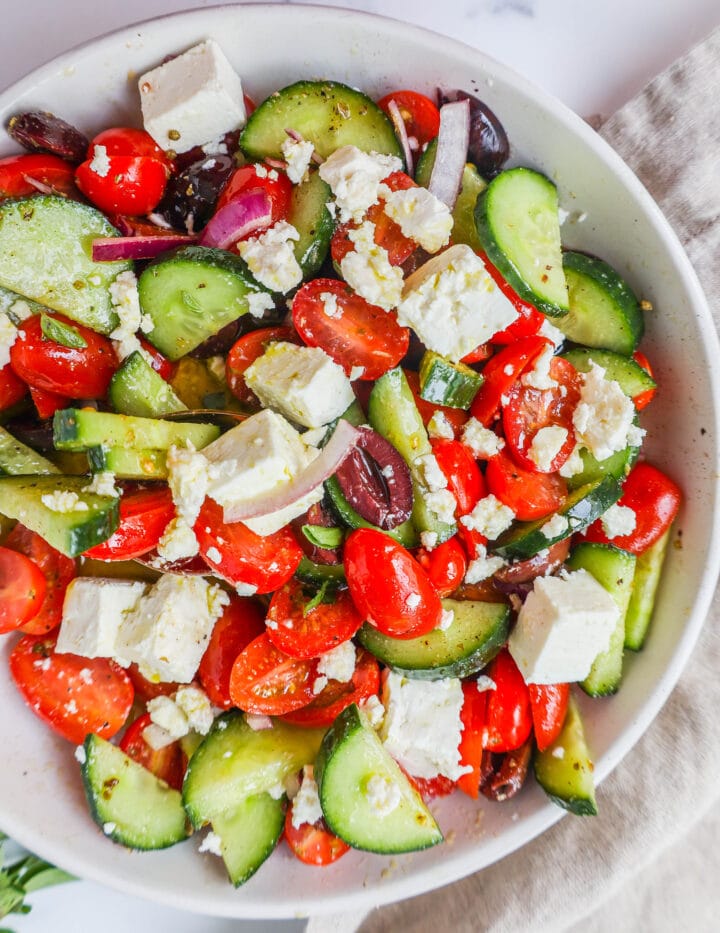 This simple Greek Salad is made with fresh tomatoes, cucumbers, red onion, kalamata olives, feta cheese, and all tossed with a homemade tangy Greek dressing. 