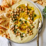 How to make authentic, creamy, homemade hummus made from scratch using simple ingredients -- chickpeas, tahini, garlic, olive oil, lemon juice, and salt. This is such an easy hummus recipe that everyone will love! 