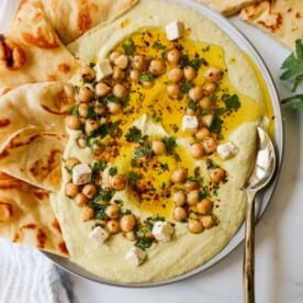 How to make authentic, creamy, homemade hummus made from scratch using simple ingredients -- chickpeas, tahini, garlic, olive oil, lemon juice, and salt. This is such an easy hummus recipe that everyone will love!