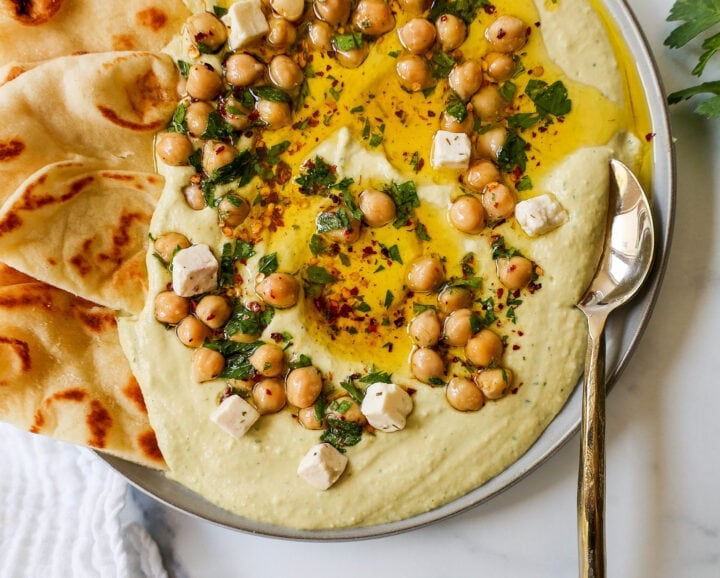 How to make authentic, creamy, homemade hummus made from scratch using simple ingredients -- chickpeas, tahini, garlic, olive oil, lemon juice, and salt. This is such an easy hummus recipe that everyone will love! 