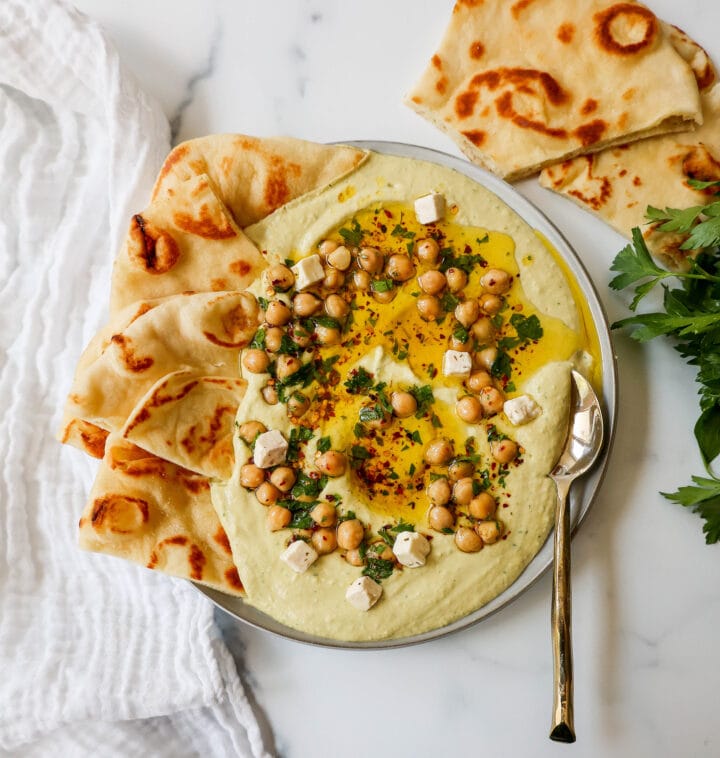 How to make authentic, creamy, homemade hummus made from scratch using simple ingredients -- chickpeas, tahini, garlic, olive oil, lemon juice, and salt. This is such an easy hummus recipe that everyone will love! 