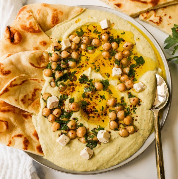 How to make authentic, creamy, homemade hummus made from scratch using simple ingredients -- chickpeas, tahini, garlic, olive oil, lemon juice, and salt. This is such an easy hummus recipe that everyone will love! 