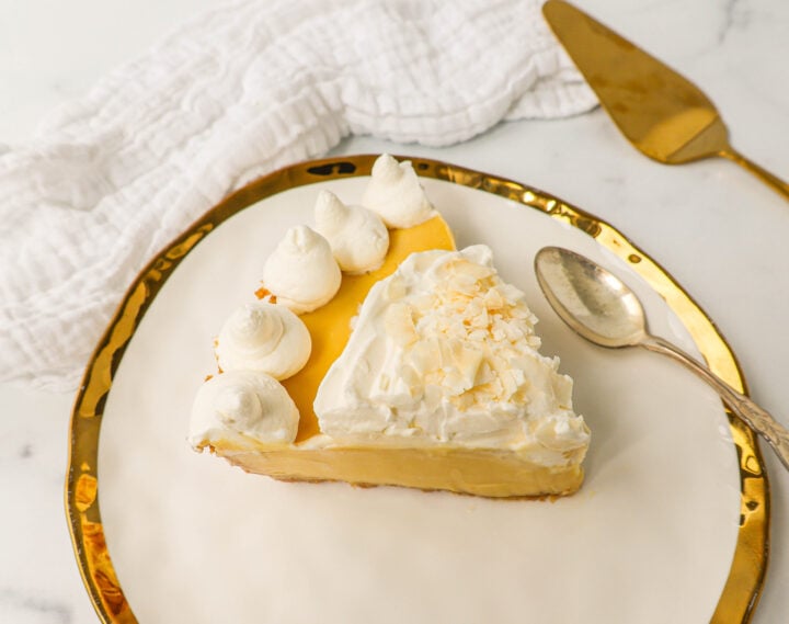 Creamy Passion Fruit Pie topped with fresh whipped cream is the perfect tropical cream pie recipe that will make you feel like you are in Hawaii! This Lilikoi Pie is similar to a key lime pie but made with passion fruit. This Passionfruit pie is made with a graham cracker crust, creamy passion fruit custard filling, and topped with billowy sweet whipped cream.
