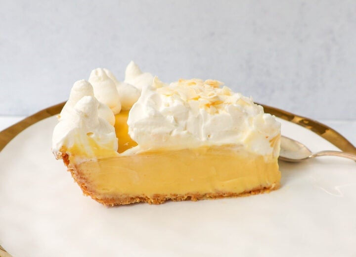 Creamy Passion Fruit Pie topped with fresh whipped cream is the perfect tropical cream pie recipe that will make you feel like you are in Hawaii! This Lilikoi Pie is similar to a key lime pie but made with passion fruit. This Passionfruit pie is made with a graham cracker crust, creamy passion fruit custard filling, and topped with billowy sweet whipped cream.