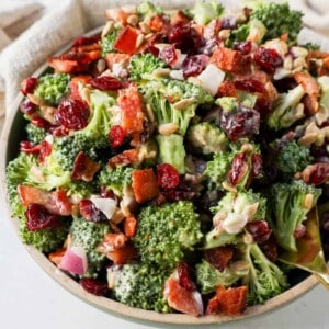 Crunchy, easy broccoli salad with crispy bacon, sweet dried cranberries, onion, and nuts all tossed in a sweet and tangy dressing. Tips for making the best broccoli salad. A classic potluck, BBQ, or summer side dish recipe!