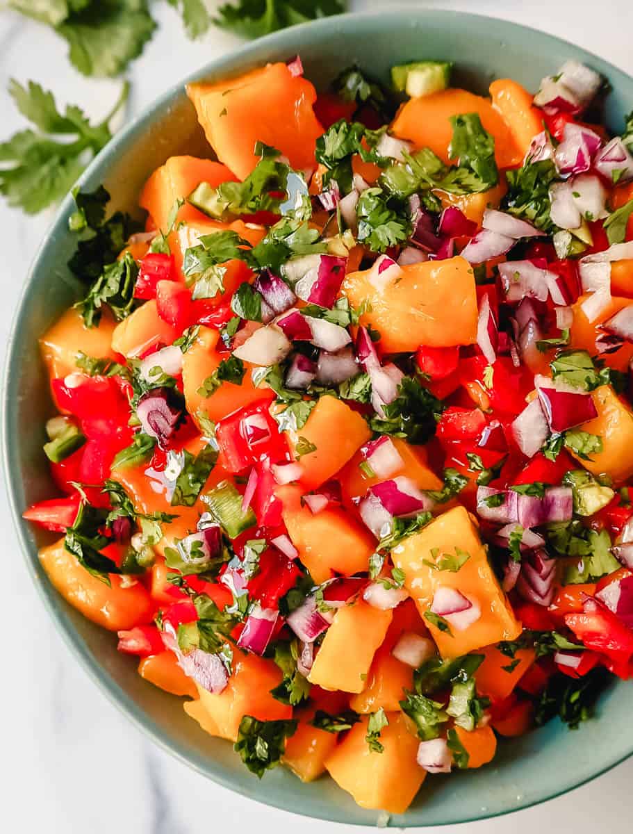 How to make the best mango salsa. Homemade Fresh Mango Salsa with ripe mango, red peppers, cilantro, red onion, jalapeno, lime juice, salt, and a touch of honey. The freshest and best mango salsa recipe!