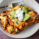 Chicken enchiladas with red sauce are made with soft and savory corn tortillas, shredded chicken, warm and flavorful red sauce from scratch and topped with Mexican crema and cheese.