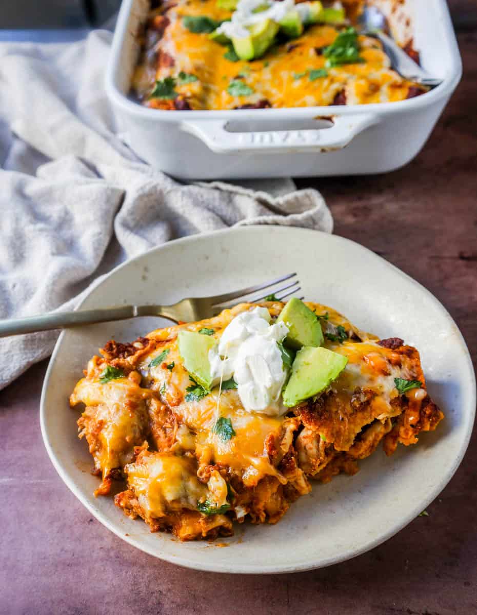 Chicken enchiladas with red sauce are made with soft and savory corn tortillas, shredded chicken, warm and flavorful red sauce from scratch and topped with Mexican crema and cheese