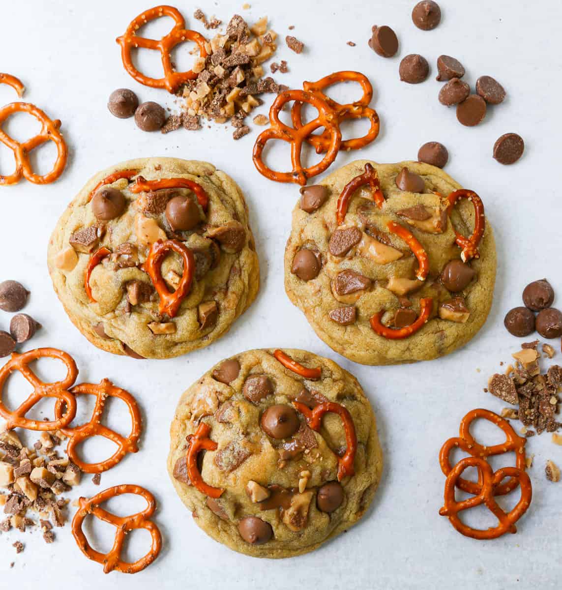 Three thick and chewy chocolate toffee pretzel cookies made with crushed pretzels, chopped toffee, and milk chocolate chips.