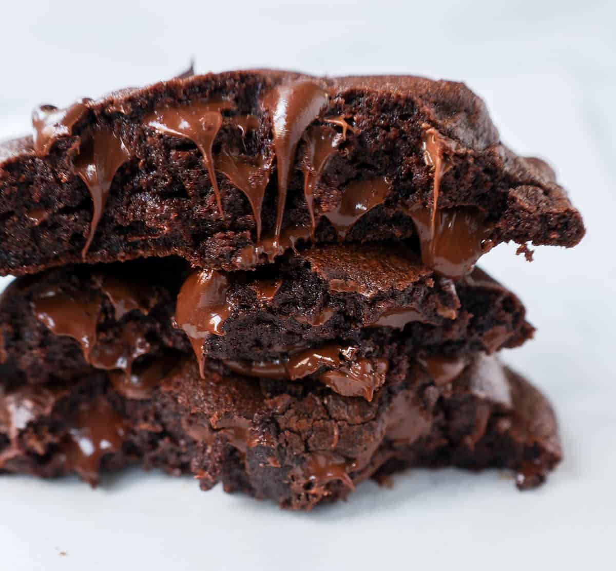 Stacked double chocolate chip cookies with melty chocolate chips.
