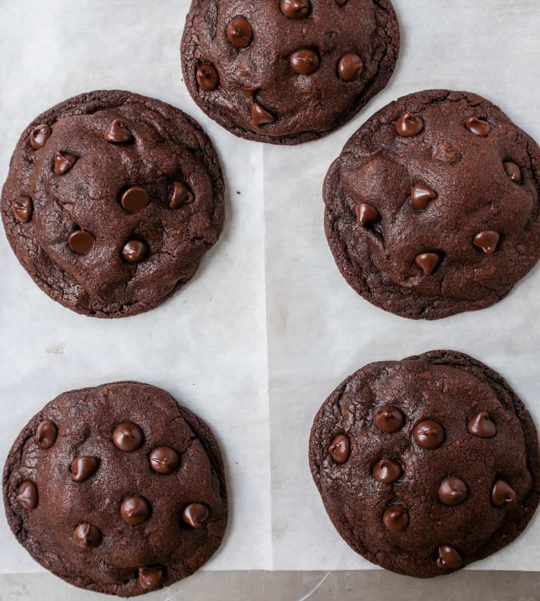 Baked cookies on a baking sheet lined with parchment paper.