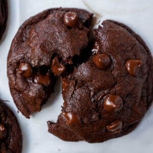 A double chocolate chip cookie split in half with melty chocolate. How to make the best double chocolate chip cookies.
