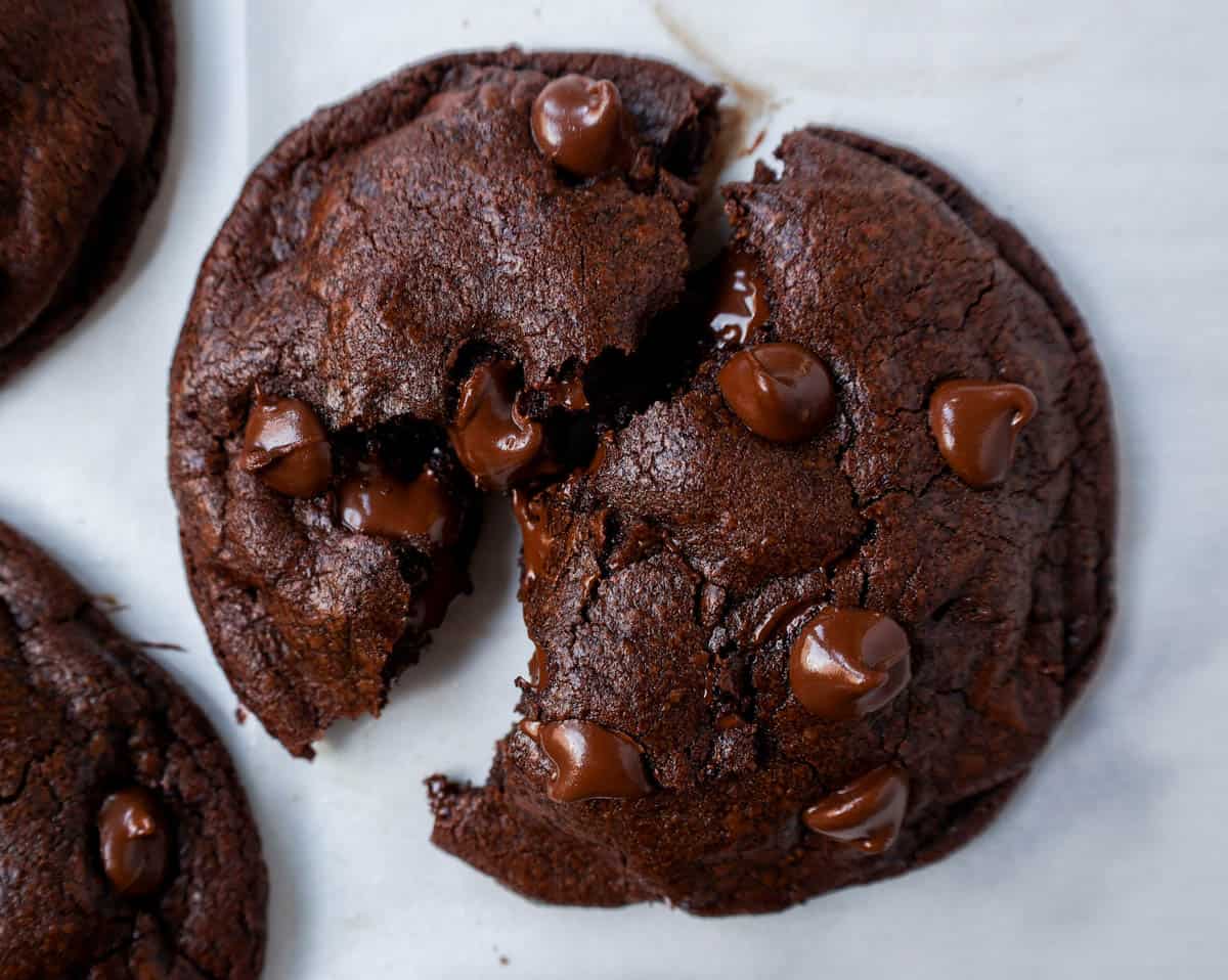 A double chocolate chip cookie split in half with melty chocolate.