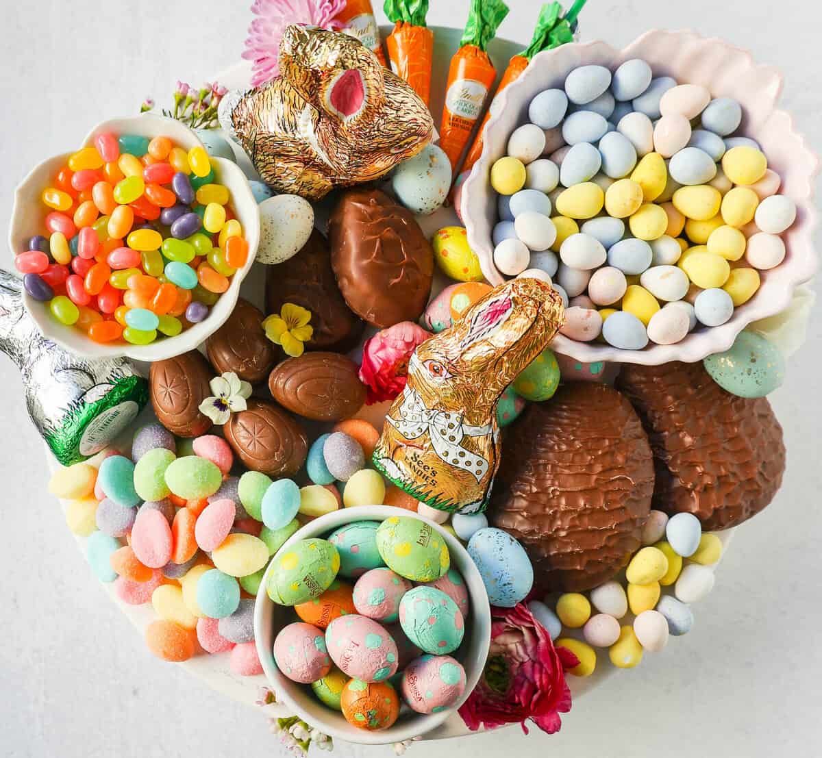 How to make a beautiful Easter Candy Charcuterie Board featuring colorful and sweet Easter candies and decadent chocolates. I will share tips for making a gorgeous Easter dessert board.