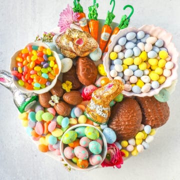 How to make a beautiful Easter Candy Charcuterie Board featuring colorful and sweet Easter candies and decadent chocolates. I will share tips for making a gorgeous Easter dessert board.