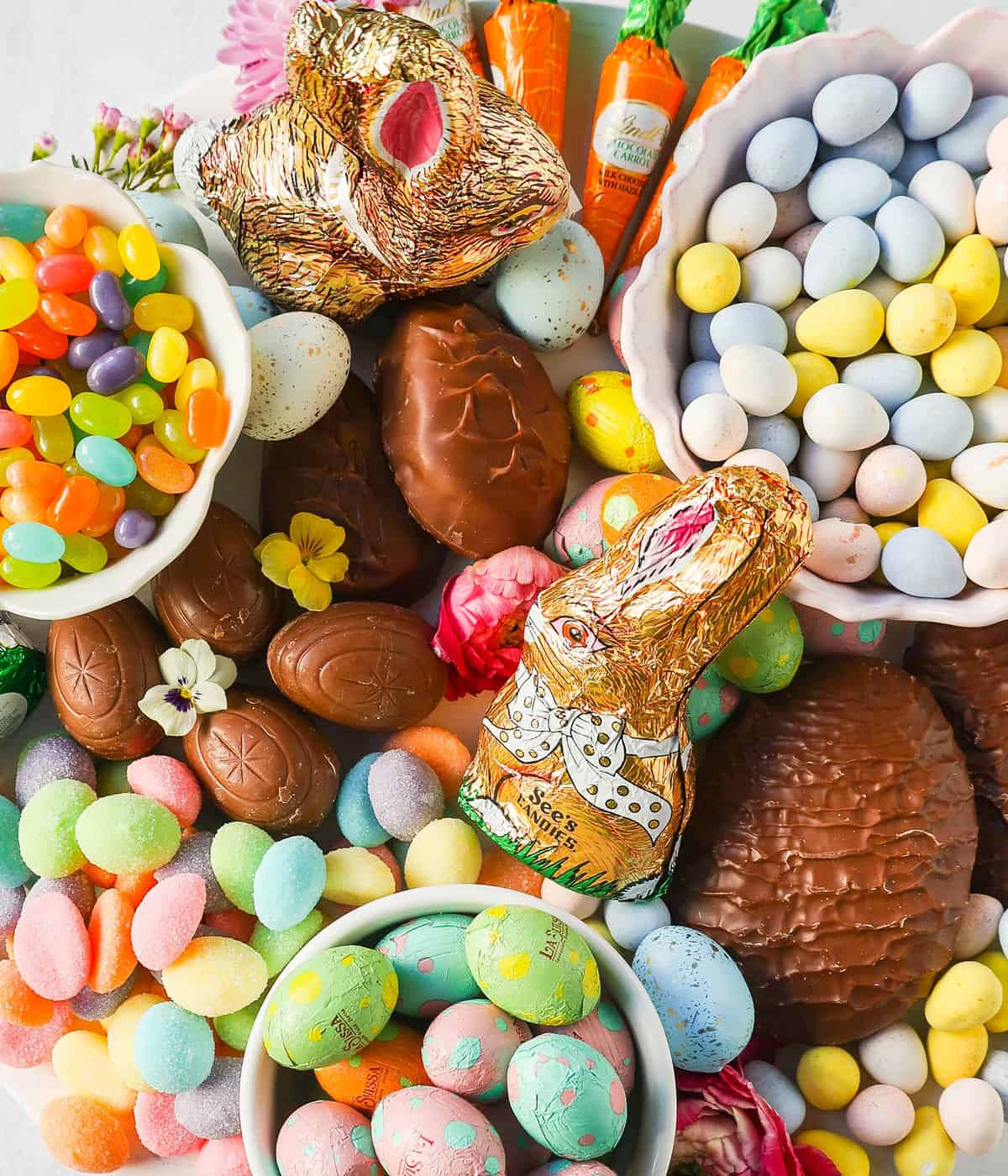 How to make a beautiful Easter Candy Charcuterie Board featuring colorful and sweet Easter candies and decadent chocolates. I will share tips for making a gorgeous Easter dessert board.