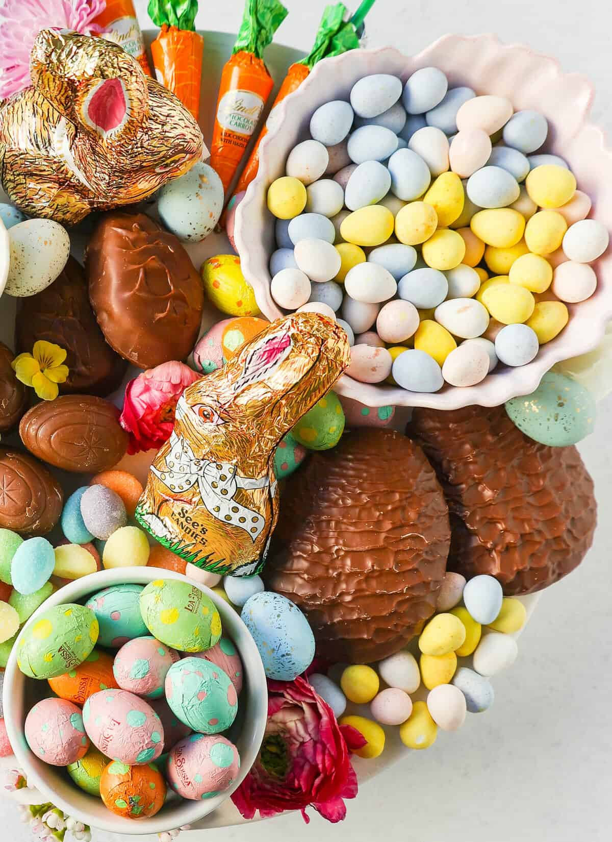 How to make a beautiful Easter Candy Charcuterie Board featuring colorful and sweet Easter candies and decadent chocolates. I will share tips for making a gorgeous Easter dessert board.