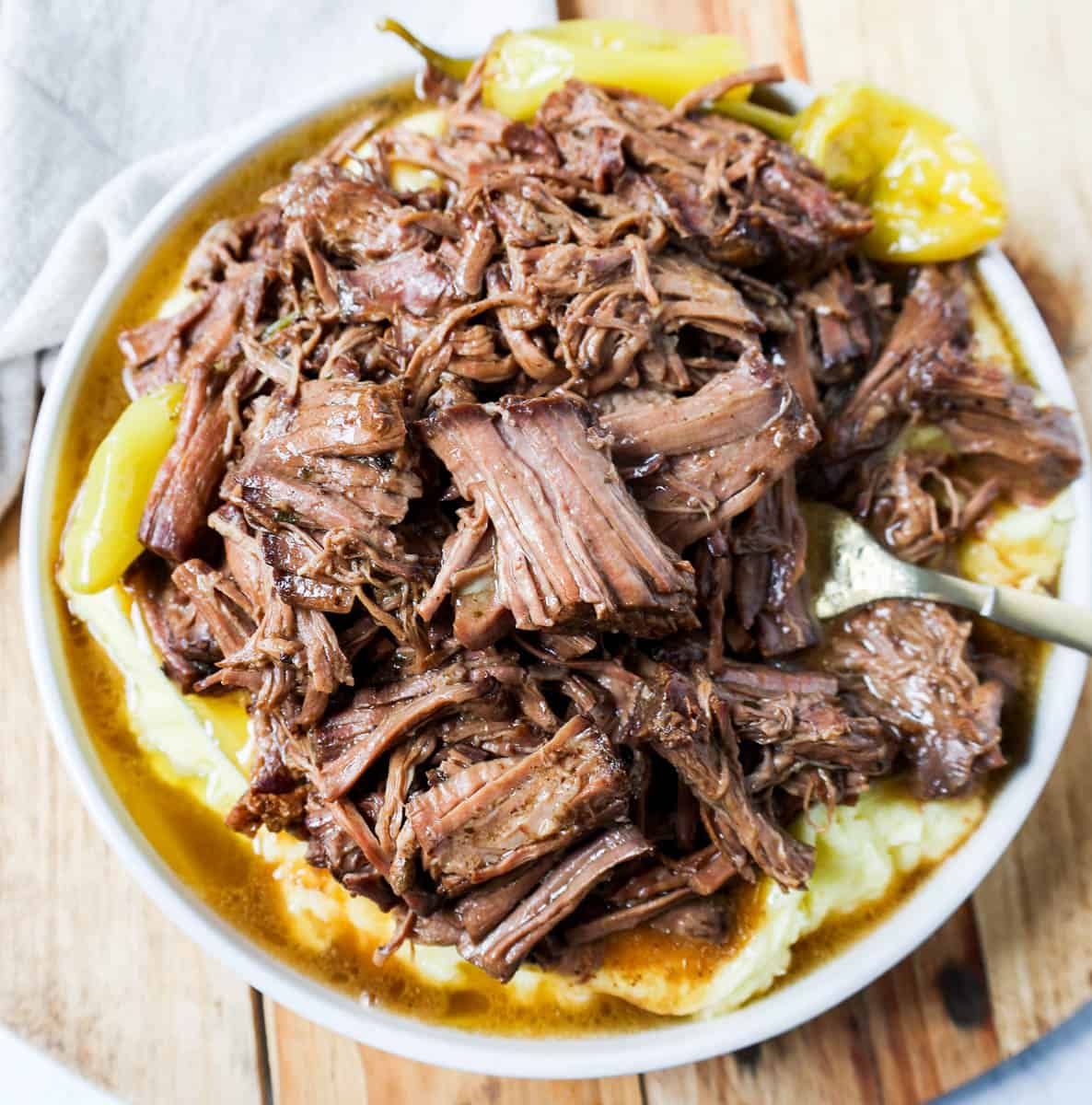 This Mississippi Pot Roast Recipe is the most tender, flavorful, melt-in-your-mouth beef roast recipe and is made with only five ingredients. This is the best beef pot roast recipe ever and is slow cooked in a crockpot.