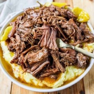 This Mississippi Pot Roast Recipe is the most tender, flavorful, melt-in-your-mouth beef roast recipe and is made with only five ingredients. This is the best beef pot roast recipe ever and is slow cooked in a crockpot.