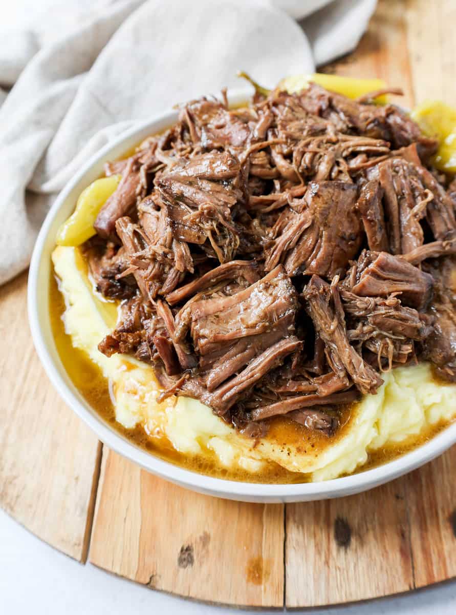 This Mississippi Pot Roast Recipe is the most tender, flavorful, melt-in-your-mouth beef roast recipe and is made with only five ingredients. This is the best beef pot roast recipe ever and is slow cooked in a crockpot.