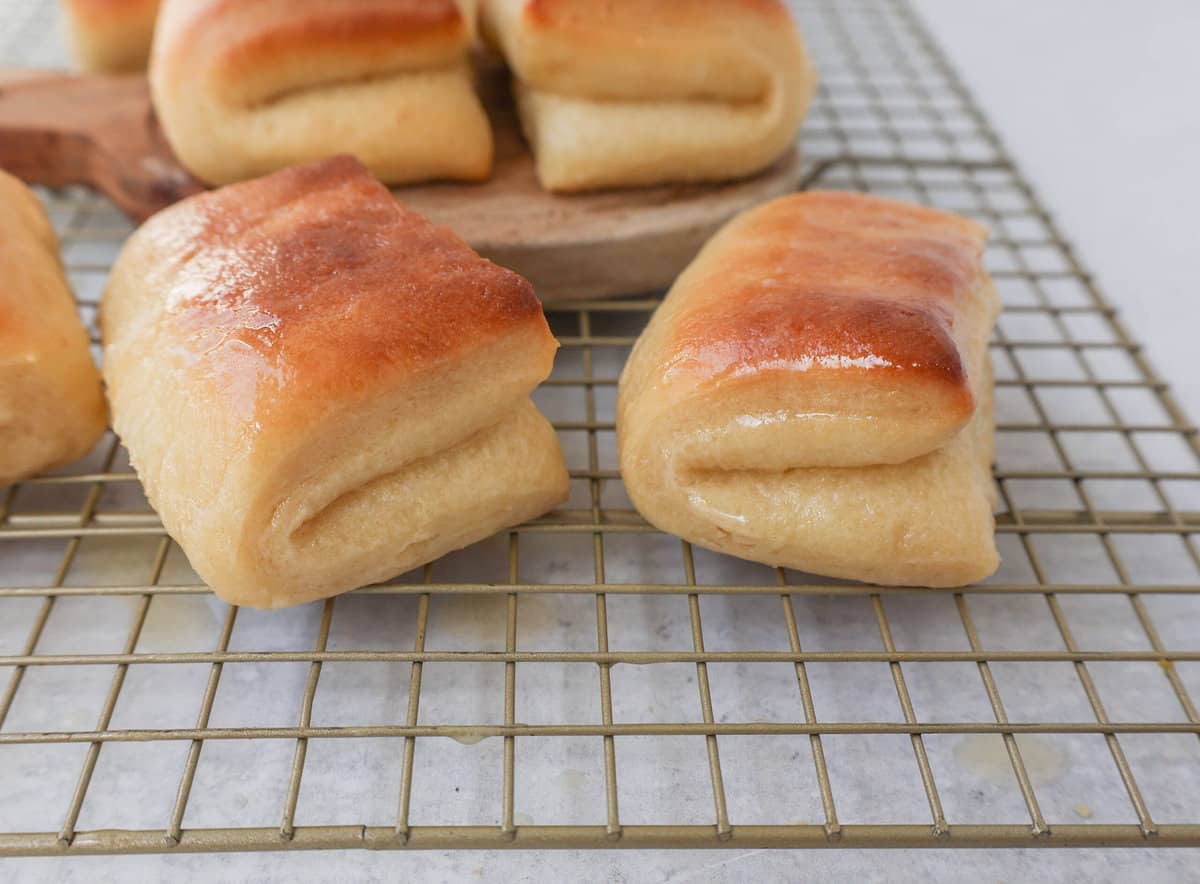 The Famous Parker House Rolls are light, fluffy, and buttery with a secret ingredient that make them tender and melt in your mouth. This the best parker house roll recipe!
