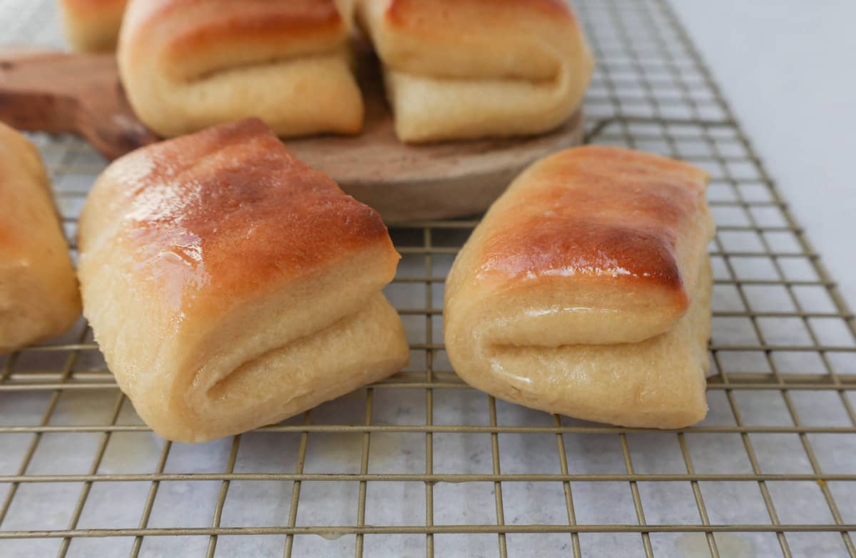 The Famous Parker House Rolls are light, fluffy, and buttery with a secret ingredient that make them tender and melt in your mouth. This the best parker house roll recipe!