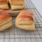 The Famous Parker House Rolls are light, fluffy, and buttery with a secret ingredient that makes them tender and melt in your mouth. This is the best Parker house roll recipe!