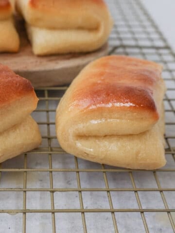 The Famous Parker House Rolls are light, fluffy, and buttery with a secret ingredient that makes them tender and melt in your mouth. This is the best Parker house roll recipe!