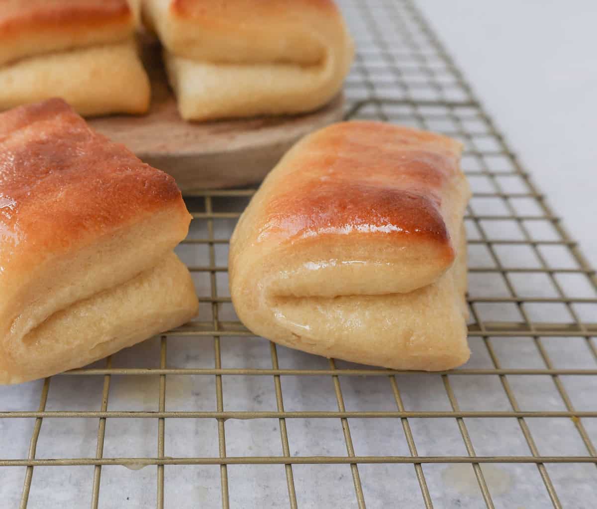 The Famous Parker House Rolls are light, fluffy, and buttery with a secret ingredient that makes them tender and melt in your mouth. This is the best Parker house roll recipe!