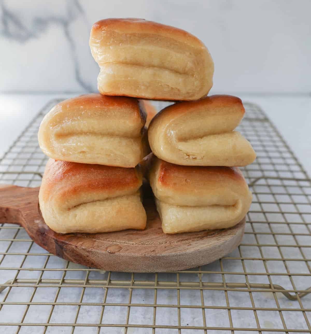 The Famous Parker House Rolls are light, fluffy, and buttery with a secret ingredient that make them tender and melt in your mouth. This the best parker house roll recipe!