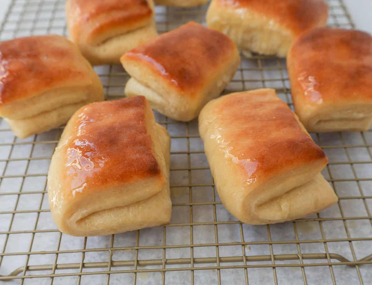 The Famous Parker House Rolls are light, fluffy, and buttery with a secret ingredient that make them tender and melt in your mouth. This the best parker house roll recipe!