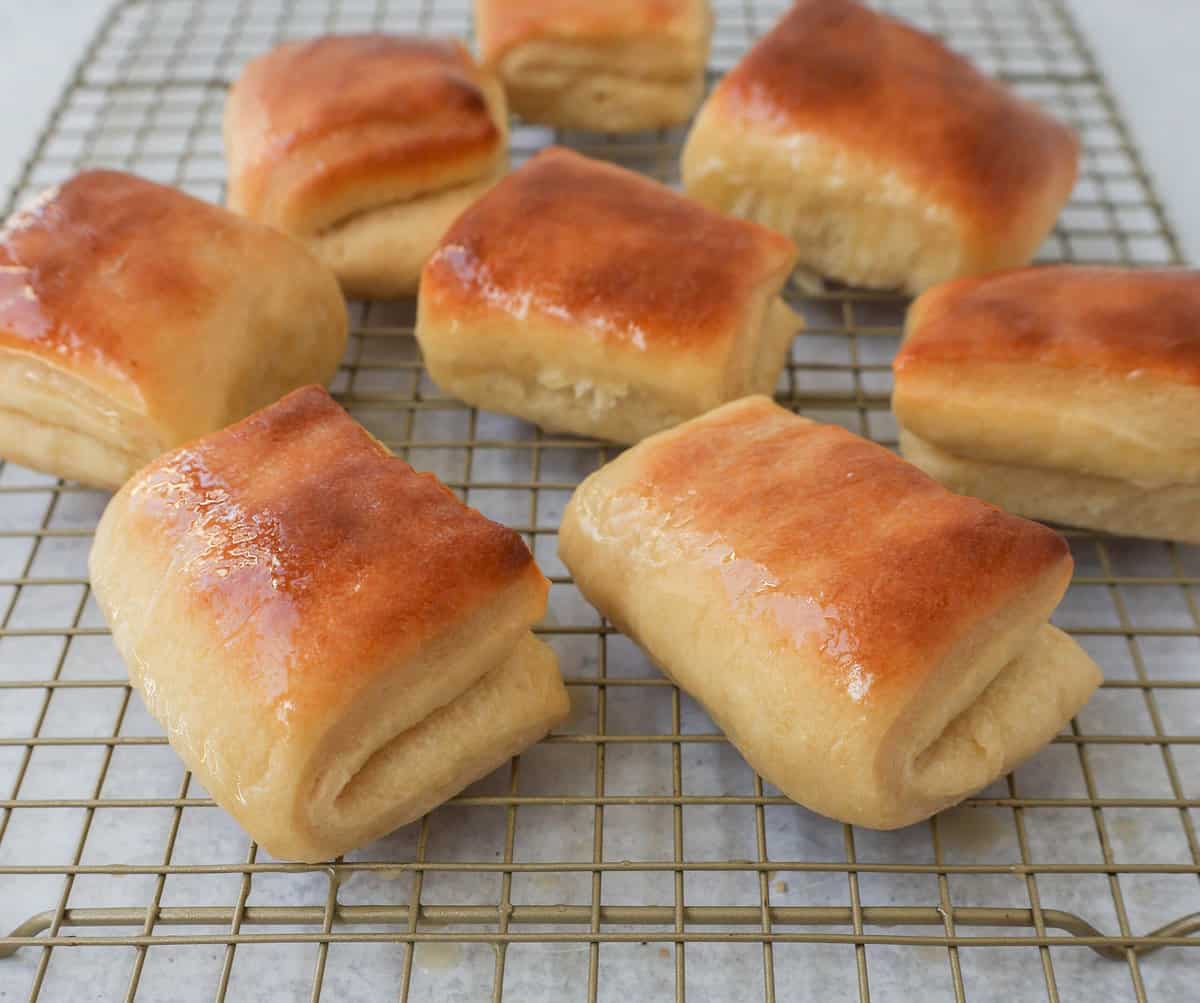 The Famous Parker House Rolls are light, fluffy, and buttery with a secret ingredient that make them tender and melt in your mouth. This the best parker house roll recipe!