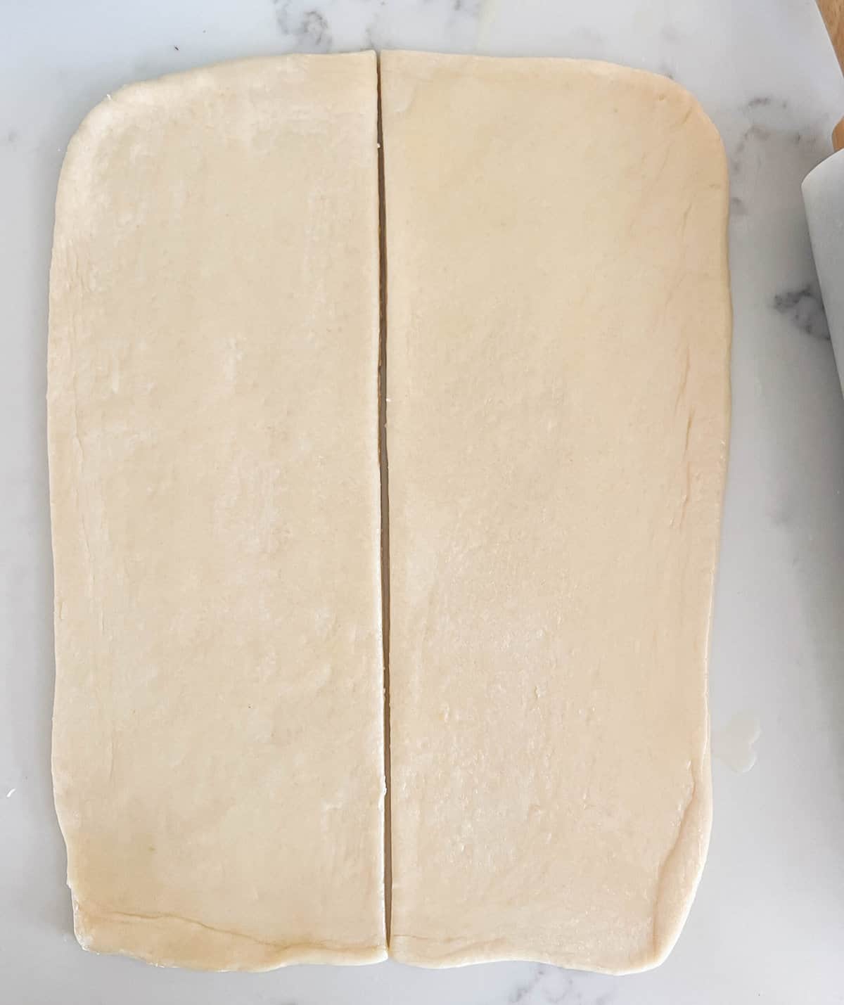 Parker House Dough Ball into rectangle and cutting in half. How to make homemade Parker House Rolls from scratch.