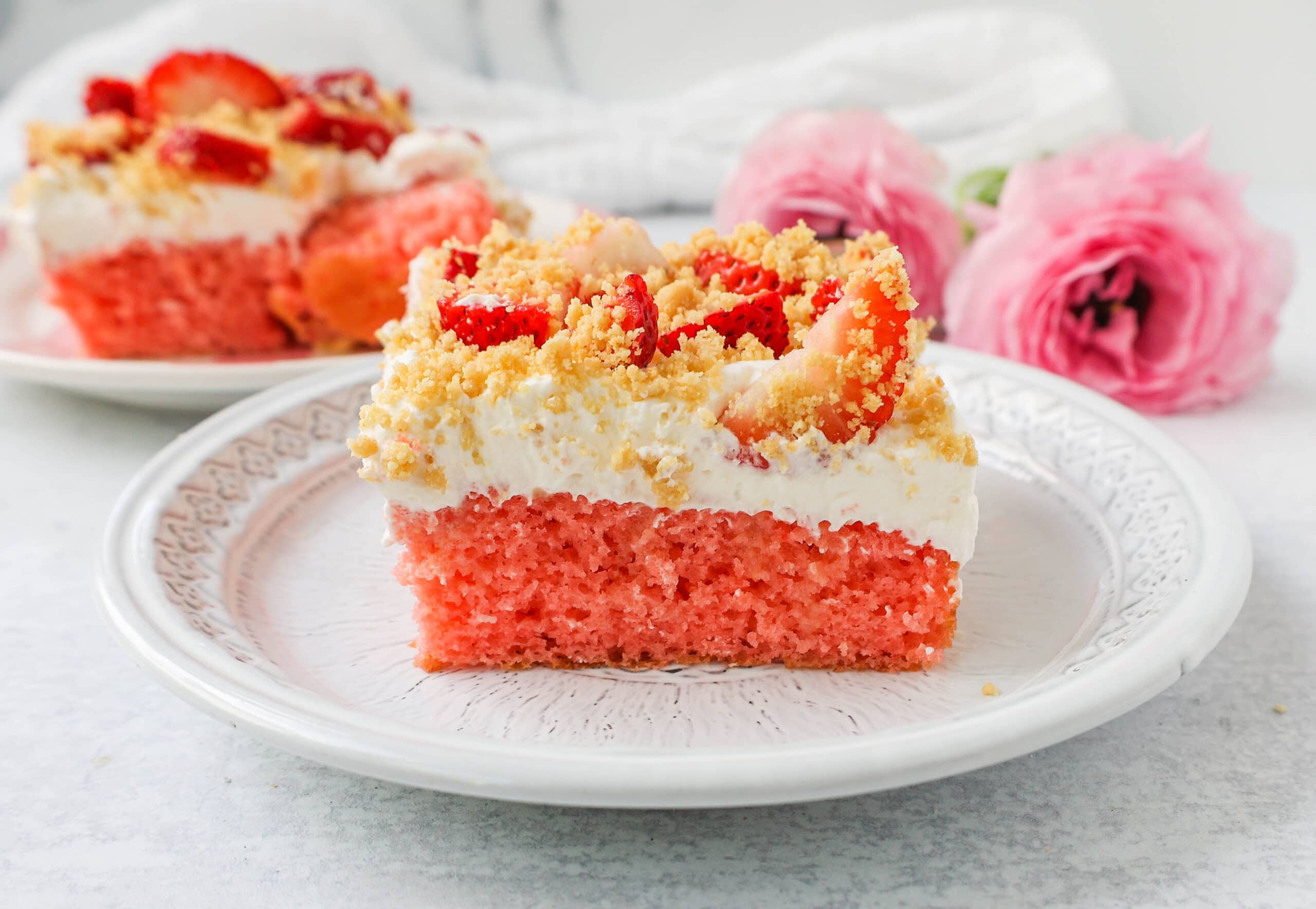 This Strawberry Cream Crunch Cake is a strawberry cake soaked with sweetened condensed milk after baking and topped with fresh sweet whipped cream, fresh strawberries, and crushed golden Oreos for crunch. This strawberry poke cake has it all!