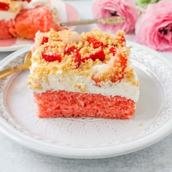 This Strawberry Cream Crunch Cake is a strawberry cake soaked with sweetened condensed milk after baking and topped with fresh sweet whipped cream, fresh strawberries, and crushed golden Oreos for crunch. This strawberry poke cake has it all!