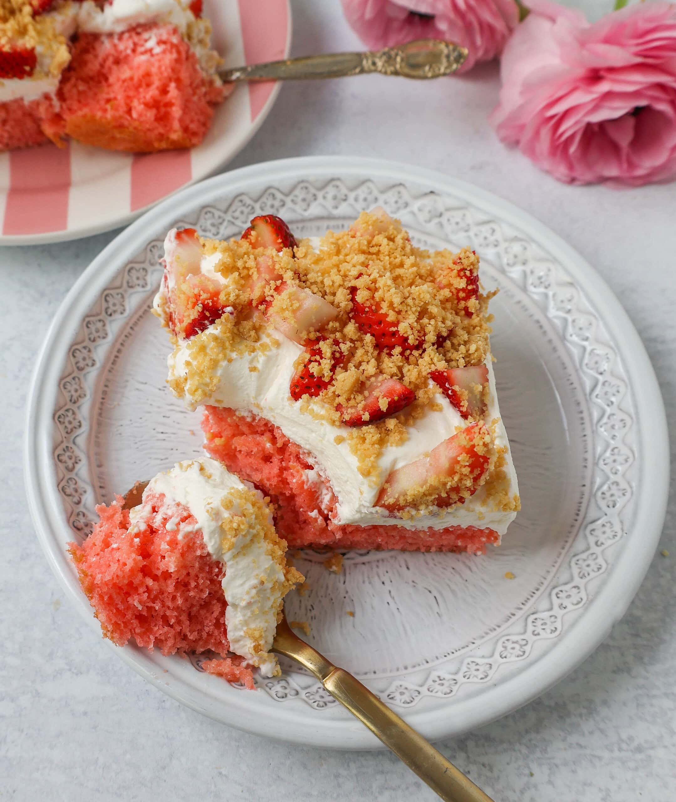 This Strawberry Cream Crunch Cake is a strawberry cake soaked with sweetened condensed milk after baking and topped with fresh sweet whipped cream, fresh strawberries, and crushed golden Oreos for crunch. This strawberry poke cake has it all!