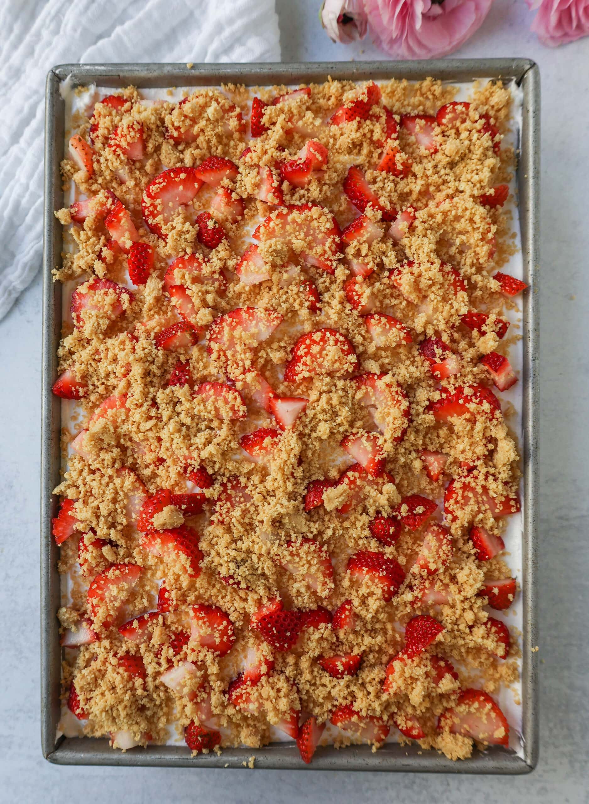 This Strawberry Cream Crunch Cake is a strawberry cake soaked with sweetened condensed milk after baking and topped with fresh sweet whipped cream, fresh strawberries, and crushed golden Oreos for crunch. This strawberry poke cake has it all!