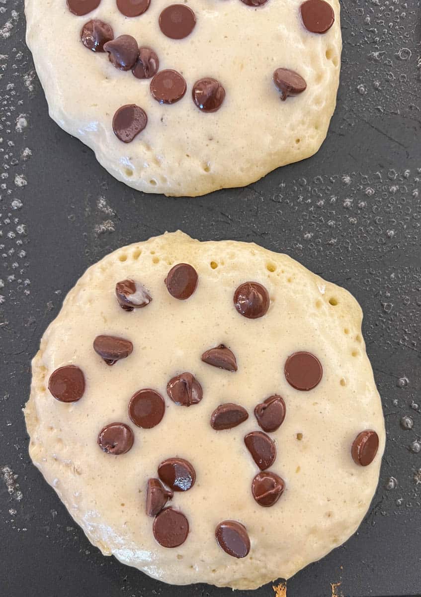 The best chocolate chip pancakes! Homemade light, fluffy buttermilk chocolate chip pancakes with sweet milk or semi-sweet chocolate chips. These easy chocolate chip pancakes make the most decadent breakfast!