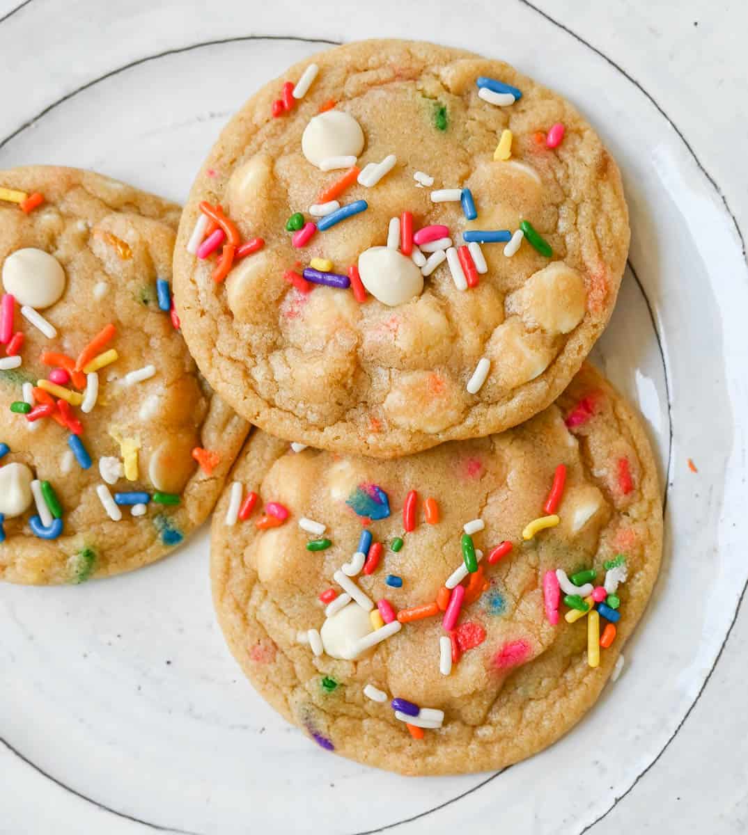 Soft, chewy sugar cookies filled with sprinkles and white chocolate. This festive funfetti cookie recipe has the perfect chewy center with buttery crisp edges filled with rainbow sprinkles. 