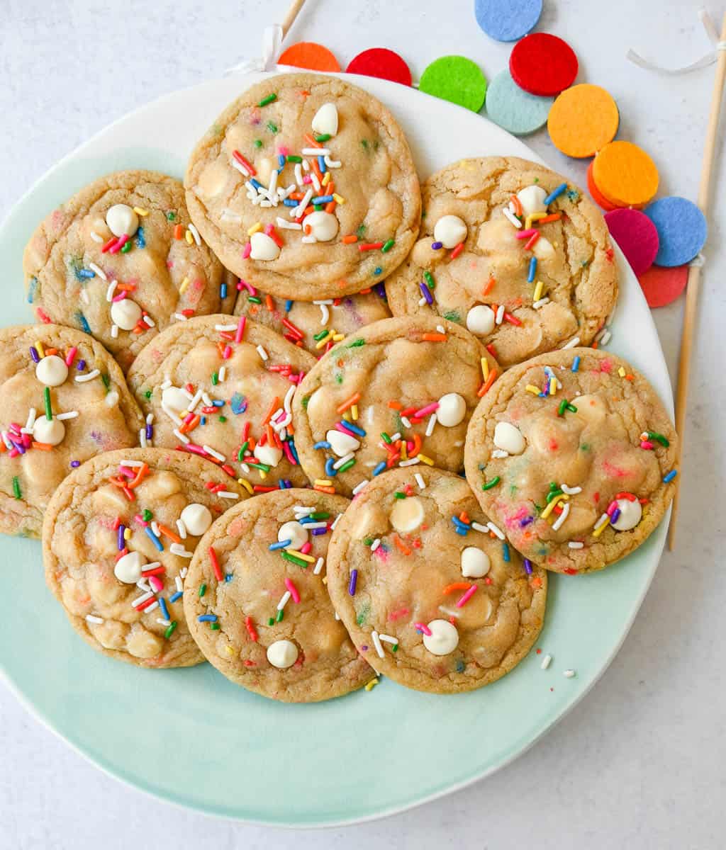 Soft, chewy sugar cookies filled with sprinkles and white chocolate. This festive funfetti cookie recipe has the perfect chewy center with buttery crisp edges filled with rainbow sprinkles.