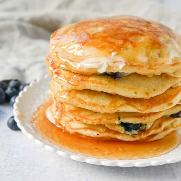 Homemade fluffy blueberry pancakes are made with fresh blueberries and are the best buttermilk blueberry pancakes ever! These are easy blueberry pancakes made from scratch.