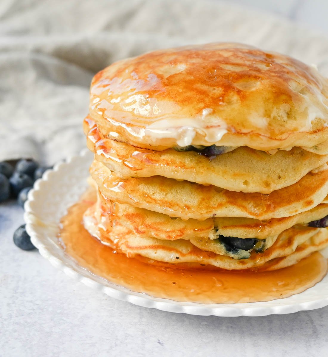 Homemade fluffy blueberry pancakes are made with fresh blueberries and are the best buttermilk blueberry pancakes ever! These are easy blueberry pancakes made from scratch.